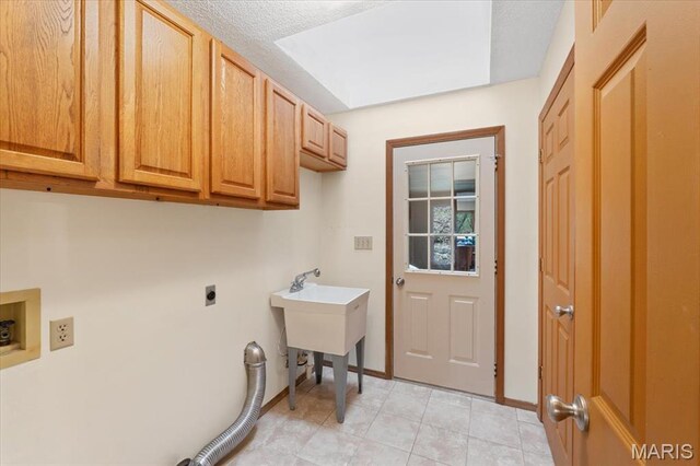 1346 Forest Splendor Trl, Wildwood, MO 63021 - laundry room with cabinet space, electric dryer hookup, washer hookup, baseboards, and light tile patterned flooring