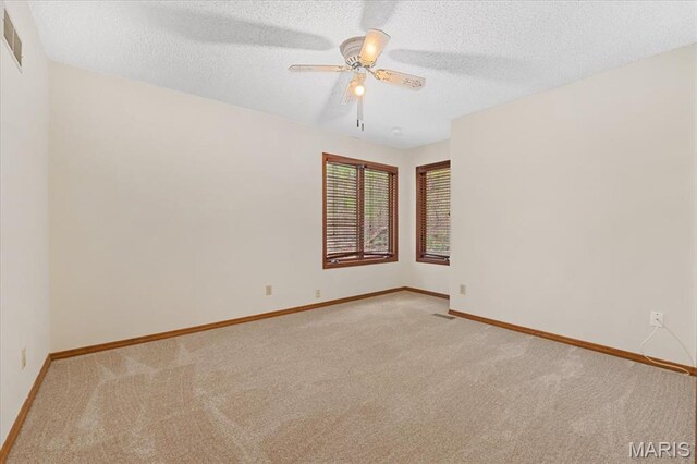 1346 Forest Splendor Trl, Wildwood, MO 63021 - unfurnished room featuring light carpet, a ceiling fan, baseboards, and a textured ceiling