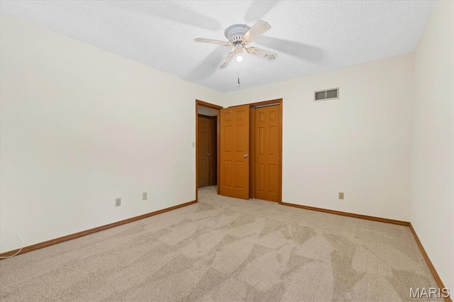 1346 Forest Splendor Trl, Wildwood, MO 63021 - unfurnished bedroom with light carpet, a textured ceiling, baseboards, a closet, and ceiling fan