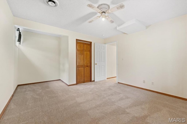 1346 Forest Splendor Trl, Wildwood, MO 63021 - unfurnished bedroom featuring carpet floors, baseboards, ceiling fan, a closet, and a textured ceiling