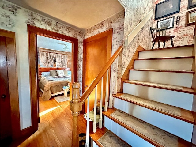 207 S Main St, Licking, MO 65542 - stairs with wallpapered walls and wood finished floors
