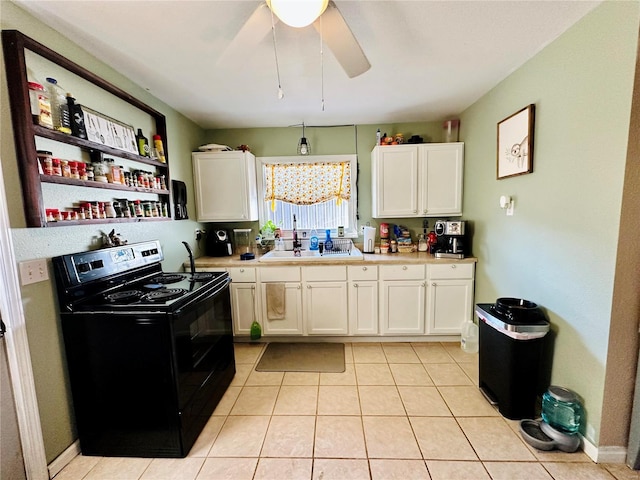 207 S Main St, Licking, MO 65542 - kitchen featuring black electric range, light countertops, a sink, white cabinets, and light tile patterned flooring