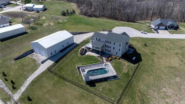 aerial view of property and surrounding area with a pool area