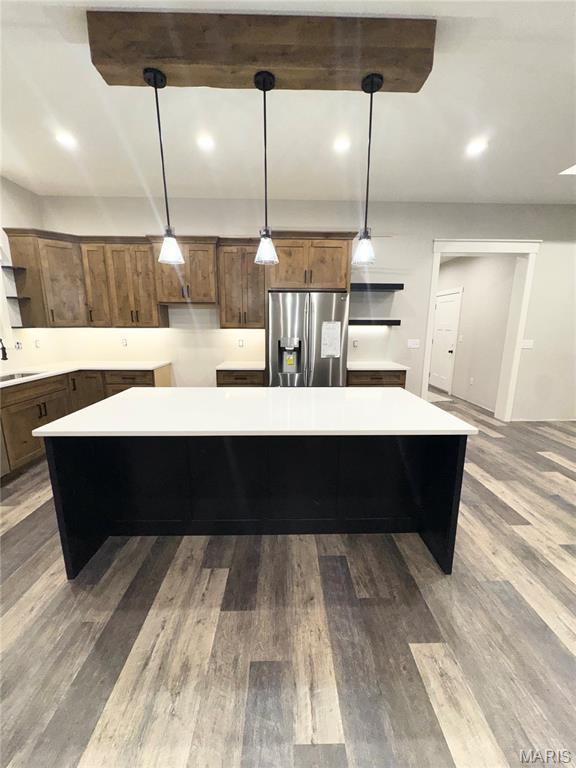 615 Scottsvale Dr, Rolla, MO 65401 - kitchen featuring stainless steel fridge with ice dispenser, open shelves, a sink, a kitchen island, and light countertops