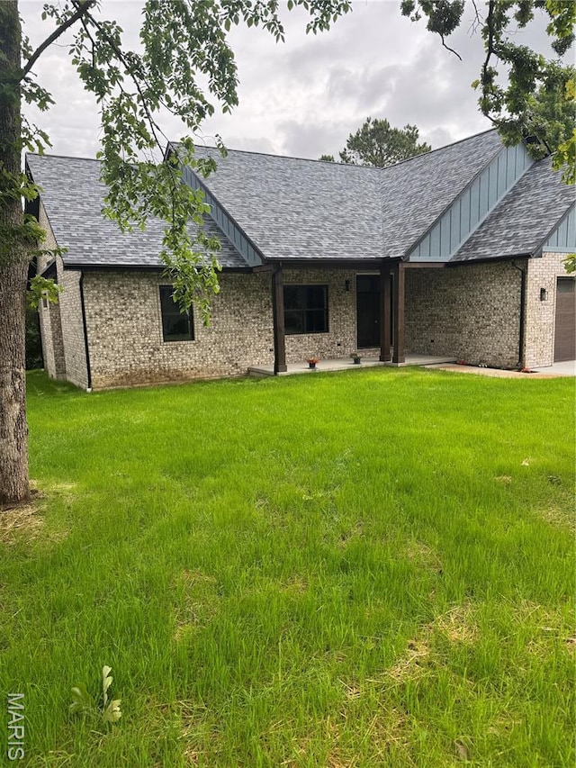 615 Scottsvale Dr, Rolla, MO 65401 - ranch-style home with a front yard, board and batten siding, and brick siding