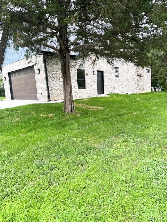 615 Scottsvale Dr, Rolla, MO 65401 - view of front of house with a front yard, board and batten siding, and a garage