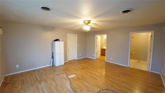 204 W 8th St, Kennett, MO 63857 - unfurnished bedroom with light wood finished floors, baseboards, connected bathroom, and a ceiling fan