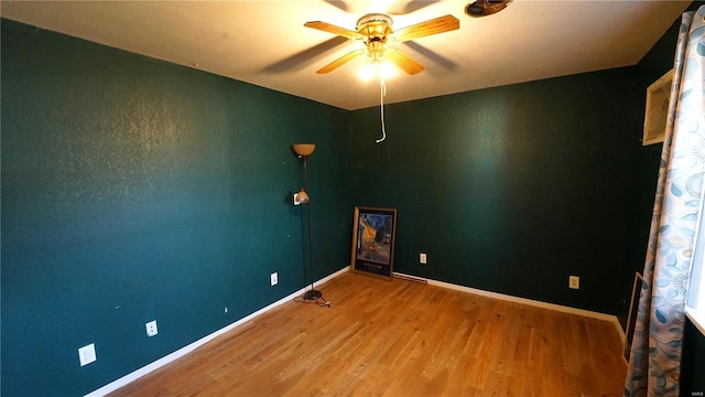 204 W 8th St, Kennett, MO 63857 - spare room featuring wood finished floors, a ceiling fan, and baseboards