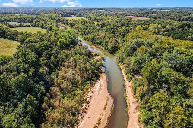 aerial view of a heavily wooded area and a large body of water