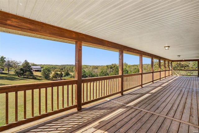 wooden deck featuring a yard