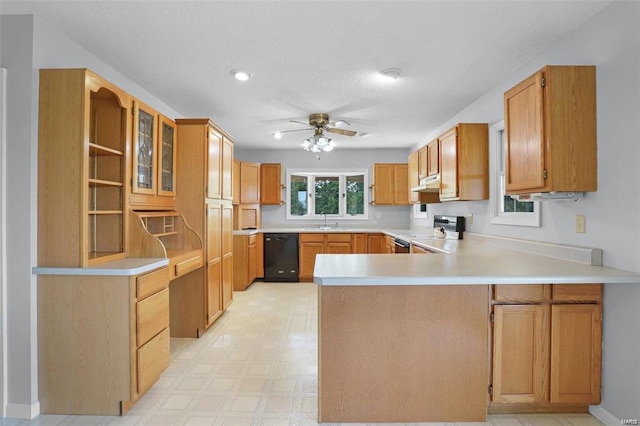 kitchen with range, a sink, black dishwasher, a peninsula, and under cabinet range hood