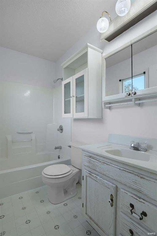full bathroom featuring tub / shower combination, toilet, vanity, and tile patterned floors