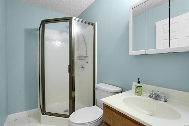 full bathroom with a stall shower, toilet, a textured ceiling, and vanity