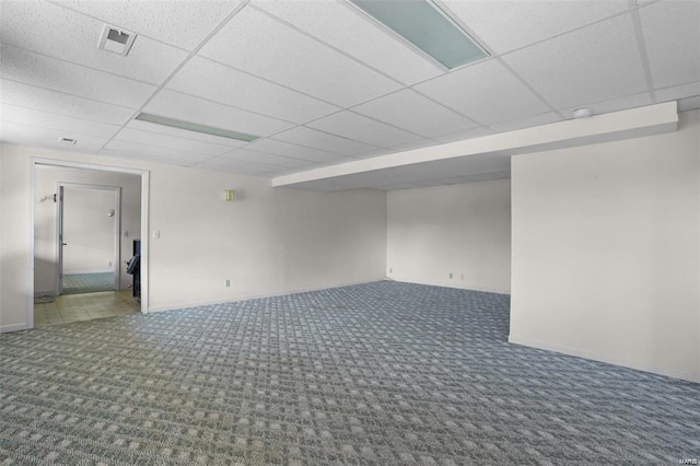 finished basement featuring carpet and a paneled ceiling