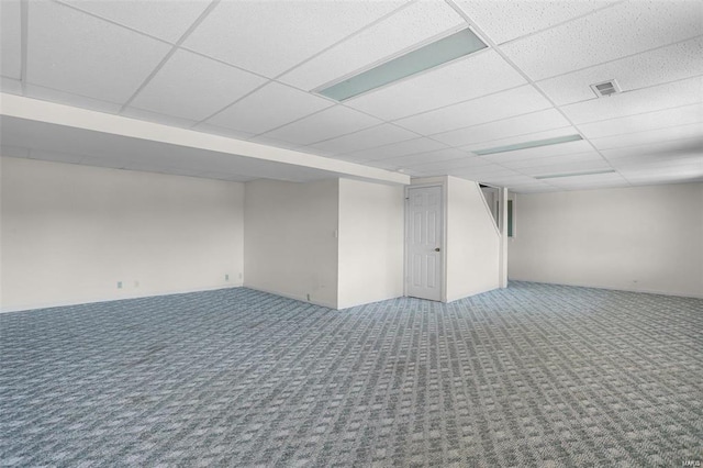 finished basement featuring carpet and a paneled ceiling