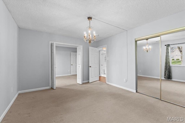 1436 Peacock Ln, Saint Louis, MO 63144 - unfurnished bedroom featuring a chandelier, carpet, a textured ceiling, a closet, and baseboards