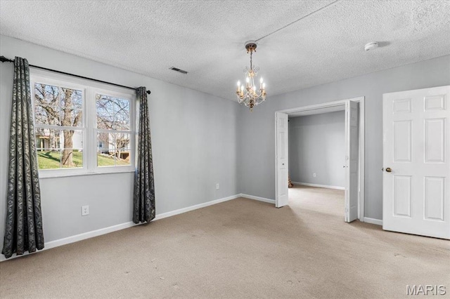 1436 Peacock Ln, Saint Louis, MO 63144 - carpeted empty room featuring a chandelier, baseboards, a textured ceiling, and a smoke detector