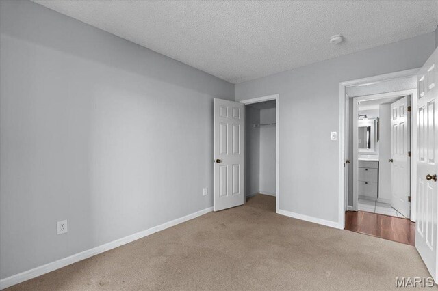 1436 Peacock Ln, Saint Louis, MO 63144 - unfurnished bedroom with carpet, baseboards, a textured ceiling, and a closet