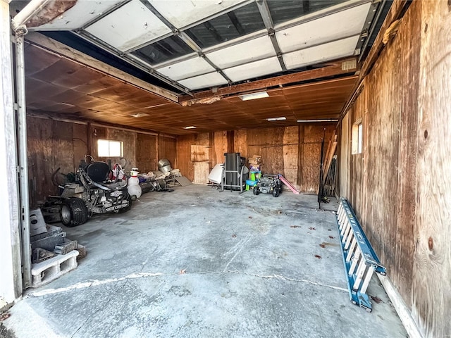 garage featuring wood walls