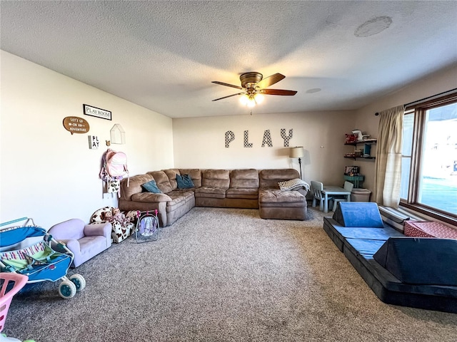 carpeted living room featuring ceiling fan and a textured ceiling