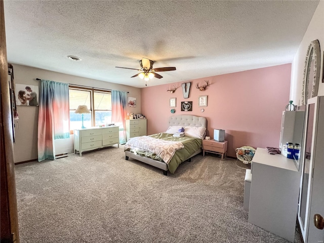 carpeted bedroom featuring a textured ceiling and a ceiling fan