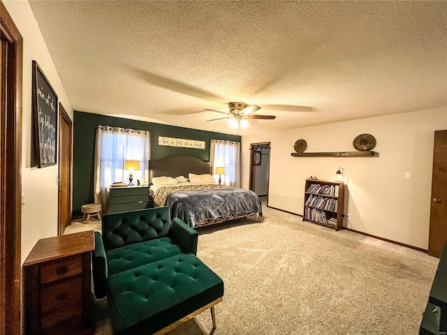 bedroom with carpet floors, a textured ceiling, ceiling fan, and baseboards