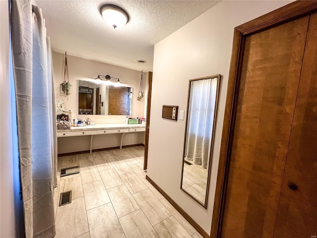 bathroom with a textured ceiling and vanity