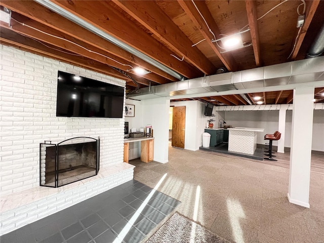 finished basement with baseboards and a fireplace
