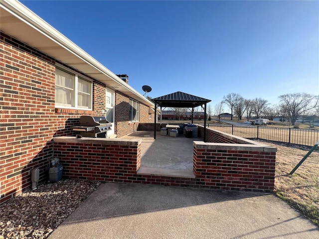 view of patio / terrace featuring a gazebo, fence, and a grill