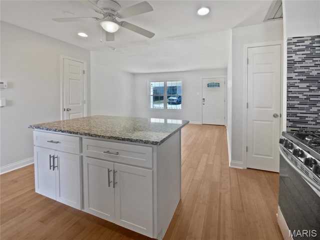 1248 Green Knoll Dr, Fenton, MO 63026 - kitchen featuring stainless steel gas range oven, light wood-style flooring, ceiling fan, stone countertops, and recessed lighting