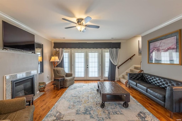 24345 State Route Ww Unit 40/41, Saint Genevieve, MO 63670 - living area featuring crown molding, ceiling fan, a premium fireplace, stairway, and wood finished floors