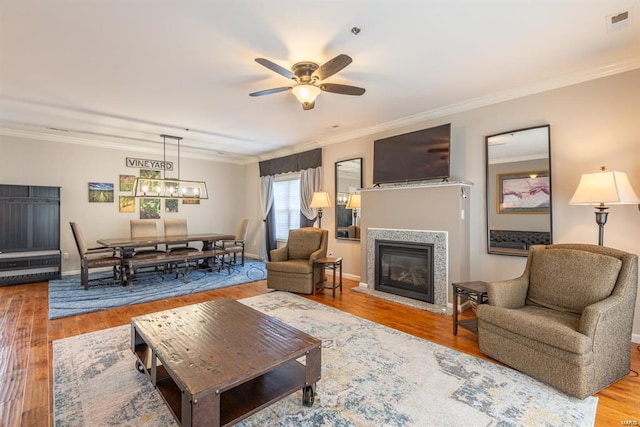 24345 State Route Ww Unit 40/41, Saint Genevieve, MO 63670 - living area with a ceiling fan, wood finished floors, crown molding, a glass covered fireplace, and baseboards