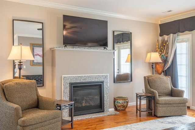 24345 State Route Ww Unit 40/41, Saint Genevieve, MO 63670 - living area with ornamental molding, wood finished floors, baseboards, and a glass covered fireplace
