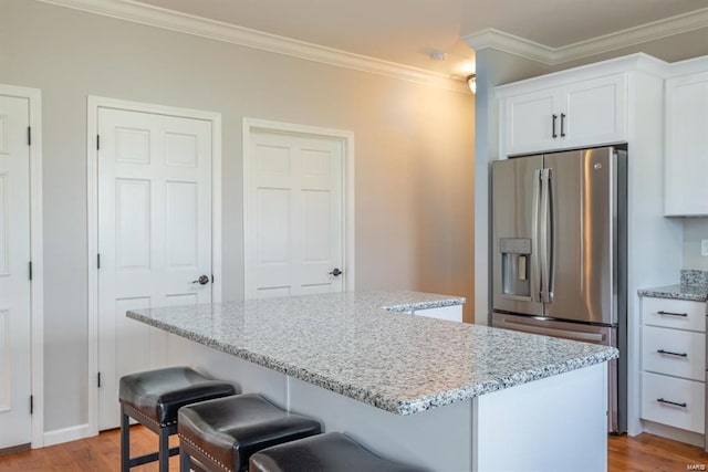 24345 State Route Ww Unit 40/41, Saint Genevieve, MO 63670 - kitchen featuring stainless steel refrigerator with ice dispenser, a center island, wood finished floors, a breakfast bar area, and white cabinets