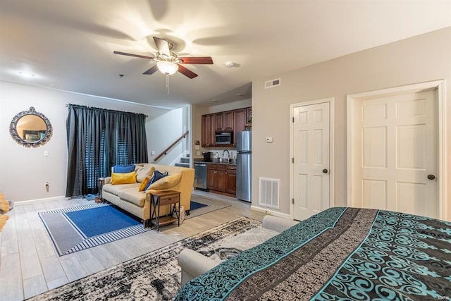 24345 State Route Ww Unit 40/41, Saint Genevieve, MO 63670 - bedroom with freestanding refrigerator, baseboards, light wood-style flooring, and ceiling fan