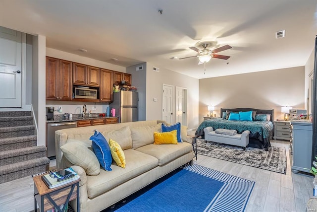 24345 State Route Ww Unit 40/41, Saint Genevieve, MO 63670 - living area with ceiling fan, light wood-style floors, and stairs