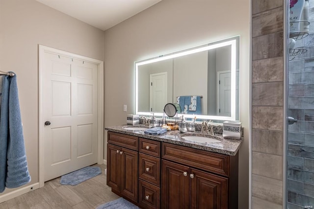 24345 State Route Ww Unit 40/41, Saint Genevieve, MO 63670 - bathroom featuring double vanity, wood finished floors, and tiled shower