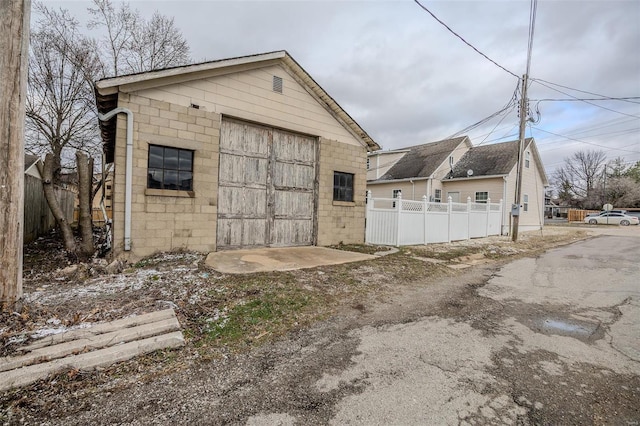 view of outbuilding featuring fence and an outdoor structure