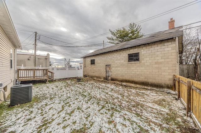fenced backyard with cooling unit and a wooden deck