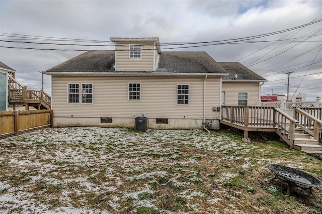 rear view of property with a wooden deck, fence, central AC, an outdoor fire pit, and roof with shingles