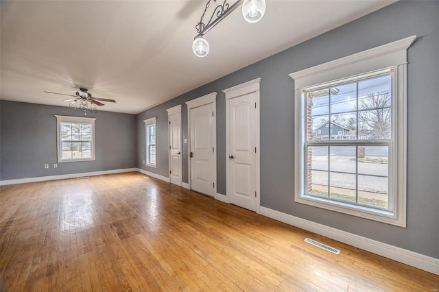 entrance foyer with baseboards, light wood finished floors, and a ceiling fan