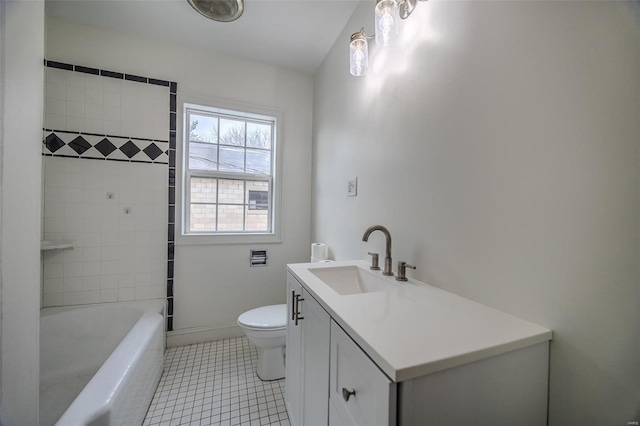 bathroom with toilet, vanity, tile patterned floors, and baseboards