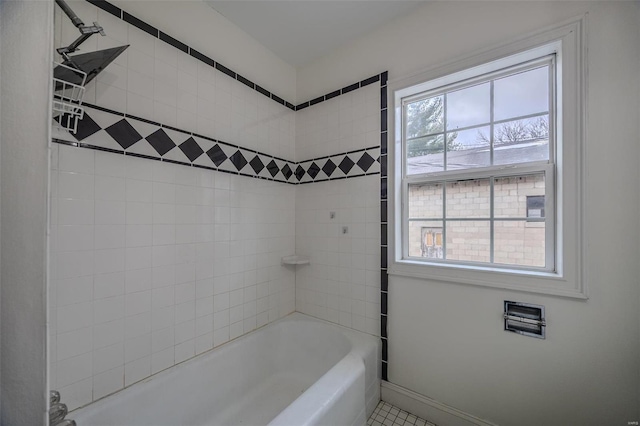 bathroom featuring baseboards, washtub / shower combination, and tile patterned floors