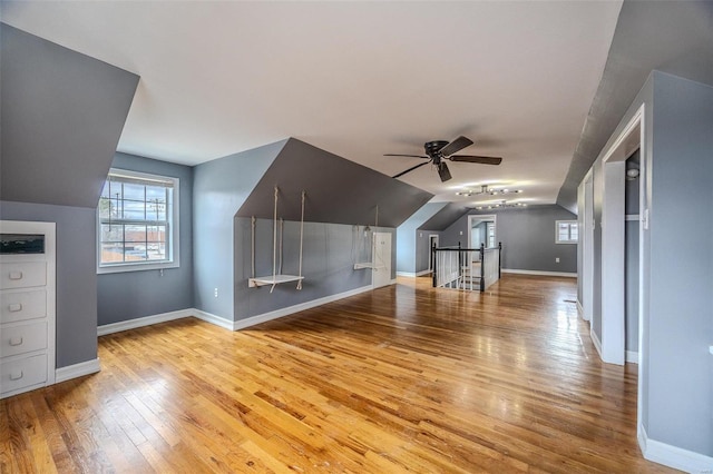 bonus room with ceiling fan, vaulted ceiling, hardwood / wood-style flooring, and baseboards