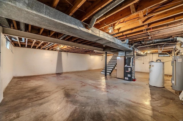 unfinished basement featuring water heater, stairway, and heating unit