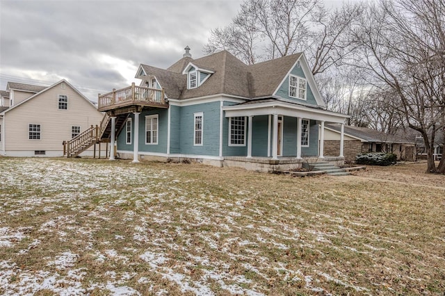 view of front of house featuring stairway, a porch, a chimney, and a deck