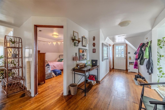 foyer featuring wood-type flooring and baseboards