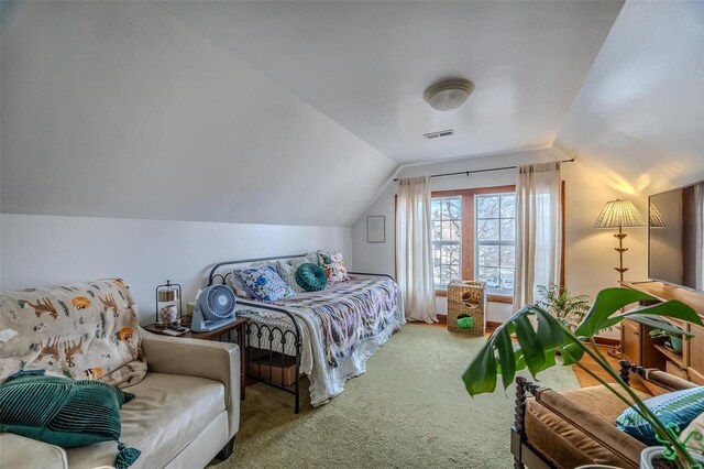 carpeted bedroom with lofted ceiling