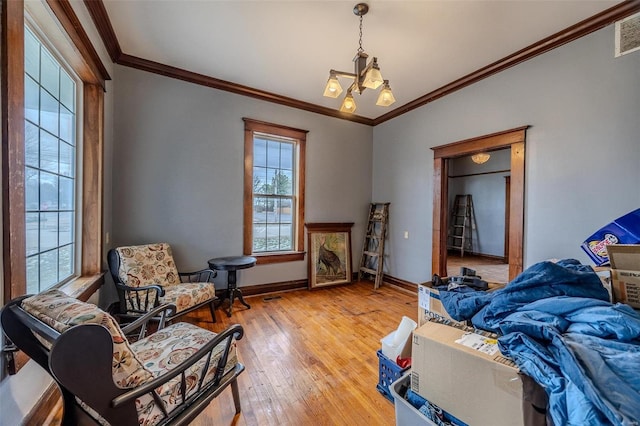 bedroom with light wood-style flooring, crown molding, and baseboards