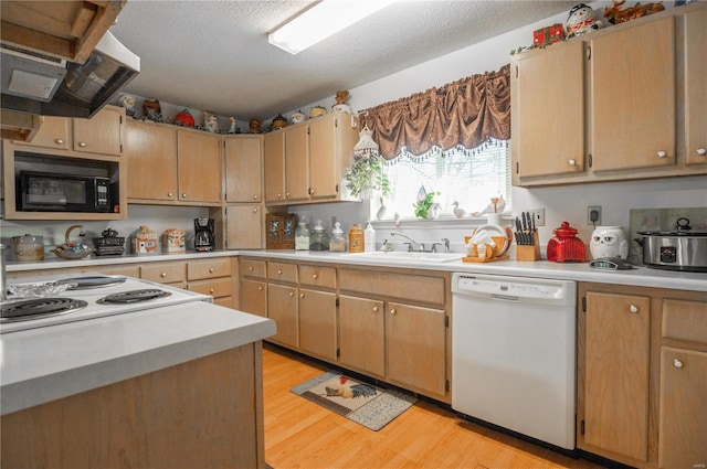 kitchen with white dishwasher, black microwave, light countertops, light wood-type flooring, and a textured ceiling